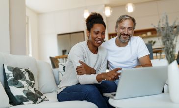Couple pointing at computer